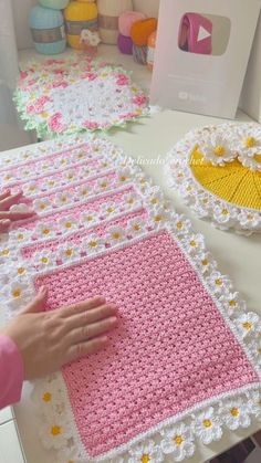 crocheted tablecloths are displayed on a table