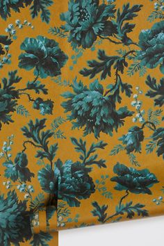 an orange and green flowered wallpaper with white flowers on the bottom half of it