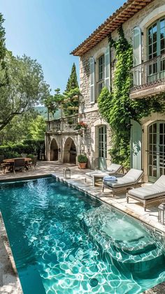 an outdoor swimming pool in front of a house