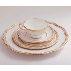 a stack of white and gold plates on top of each other