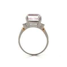 The star of this show is a stunning 9.64 carat emerald cut Kunzite. The soft pink hue of the center stone make it easy to accessorize. Adding to the glamour are six sparkling natural round brilliant cut diamonds, three on each side of the center stone. The platinum setting provides a polished backdrop for the Kunzite while and the 18 karat yellow gold accents on the shoulders add a touch of warmth to the overall design. Luxury Pink Diamond Ring For Formal Occasions, Luxury Pink Morganite Jewelry, Elegant Pink Diamond Ring In Platinum, Elegant Gia Certified Pink Diamond Ring, Elegant Pink Gia Certified Diamond Ring, Elegant Pink Platinum Rings, Elegant Morganite Radiant Cut Rings, Elegant Morganite Rings With Baguette Cut, Gia Certified Morganite Fine Jewelry