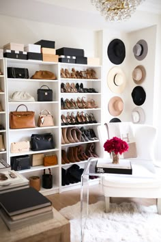 a living room filled with white furniture and lots of hats