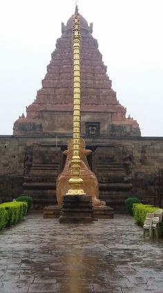 a large golden pole sitting in the middle of a courtyard