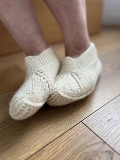 Hand-knitted sock slippers are cozy and warm, ideal for wearing around the house. Made with soft, durable yarn, these slippers provide comfort and a snug fit. The knitting technique used allows for consistent patterns and designs, ensuring that each pair is crafted to the same high standard. These slippers are a perfect blend of practicality and warmth, making them a great addition to your daily comfort or a thoughtful gift for loved ones. Handmade White Slippers With Round Toe, Folded Knitted Slippers, Thick Knitted White Socks, Grandma Slippers Knitting Patterns, Cozy Hand-knitted Slippers With Round Toe, White Sock, Knitting Techniques, Snug Fit, Hand Knitting