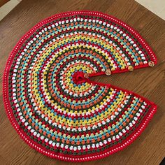 a crocheted rug on a wooden table with one piece cut out to show the pattern