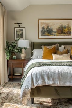 a bedroom with a bed, nightstand and paintings on the wall above it's headboard