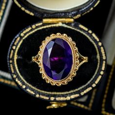 A grand vintage solitaire ring from the 1970s adorned with a luxurious oval cut amethyst weighing approx. 4.5ct with a deep, regal purple hue.  Amethyst is the birthstone of February and is considered a stone of protection, clarity and tranquillity. Its deep violet colouring has been highly esteemed throughout history, adorning regal jewellery all around the world, from ancient Egypt to the British crown jewels.  The stone is held in a 9ct gold bezel mount with roped edging and a coiling outer border. It's a striking statement piece and complete with Birmingham hallmarks, dating to 1972.  WEIGHT: 3.7 grams   SIZE: L ½ (UK), 6 (US) - Can be sized, we offer this service for free, it takes approx. 1-2 weeks to complete.    FACE MEASURES: Height 17mm x Width 13mm x Depth 7.5mm British Crown Jewels, Crown Jewels, Purple Hues, Gorgeous Jewelry, Ancient Egypt, Solitaire Ring, Rings Statement, Oval Cut, Birmingham