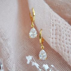 "Gold Teardrop Earrings // Boho Bridal Earrings // Short Drop Earrings // April Birthstone Earrings // Crystal Earrings // Bridesmaids Earrings // Hoops Dainty crystal teardrop earrings set with gold bezels and secured to small shiny gold plated hoops or delicate 14k gold filled earring hooks. Whether searching for boho bridal earrings for your wedding day or something for your bridesmaids your beautiful crystal earrings will arrives suitably gift wrapped ready for gift giving.  Measurements: The size of the hoops are approx. 12mm The teardrop earrings hang approx. 1\" length for both styles Metals: 14k gold plated teardrops 18k gold plated hoops // Nickel & Lead-Free //or// 14k gold filled earring hooks Complete the look with a matching teardrop necklace: https://www.etsy.com/listing/1169 Gift Drop Bridal Earrings With Ear Wire, Dangle Teardrop Earrings In Cubic Zirconia As Gift, Cubic Zirconia Teardrop Dangle Earrings As Gift, Dainty Teardrop Bridal Earrings For Gift, Dainty Teardrop Bridal Earrings, Dainty Single Teardrop Bridal Earring, Teardrop Clip-on Hoop Earrings Gift, Teardrop Clip-on Earrings For Wedding, Party Dangle Huggie Earrings