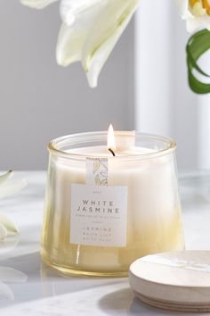 a white candle sitting on top of a table