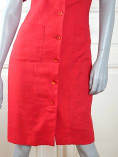 This red summer dress has a square neckline and closes in the front with eight red pearlescent buttons. The above-the-knee short-sleeve dress has figure-enhancing contour lines on the front of the bodice, padded shoulders, and two patch pockets at hip level. The back features a tie-back belt. The high-quality linen-blend dress is fully lined in red 100% acetate fabric. Condition: Near Mint (Like New ... Professionally Cleaned ... soft and supple, with no stains, tears, wear spots, or weaknesses Fitted Red Dress With Pockets, Fitted Red Dresses With Pockets, Red Fitted Dress With Pockets, Red Summer Dress With Button Closure, Red Knee-length Dress With Buttons, Knee-length Summer Dresses With Side Buttons, Dress Red Short, Vintage Clothing Women, Red Summer Dress