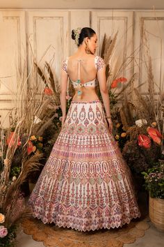 This playful lehenga is intricately embroidered with multi-hued resham threads, sequins, and glass beads and is paired with a matching blouse and mauve-pink organza dupatta.by Chamee and Palak. DELIVERY TIMEPlease allow 4-6 months for your outfit to arrive. FABRIC DETAILSRaw silk, Organza Multicolor Resham Embroidered Dress For Reception, Reception Dress With Multicolor Embroidery And Mirror Work, Wedding Lehenga With Multicolor Embroidery And Sheer Dupatta, Embellished Multicolor Embroidered Lehenga For Navratri, Navratri Embellished Multicolor Embroidery Lehenga, Embellished Multicolor Embroidery Lehenga For Navratri, Bollywood Style Embellished Multicolor Embroidery Sets, Festive Gown With Multicolor Intricate Embroidery, Festive Embellished Multicolor Embroidered Sharara