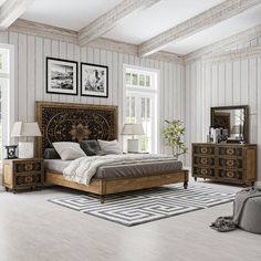 a bedroom with white walls and wooden furniture in the room, including a large bed