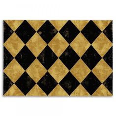 a black and gold area rug with an argyle pattern on the front, in various colors