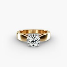 a yellow gold ring with a round diamond