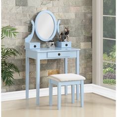 a blue vanity table with mirror and stool