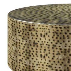 a round metal table with holes on it