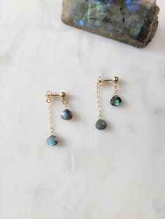 The Aurora Earrings feature the gorgeous and magical Labradorite Gemstone. I named them Aurora Earrings because the colors in Labradorite remind me of the Aurora Borealis. So beautiful!  These are stud earrings. One stone is hanging from the front and the other is attached to a chain that hangs from the backing.  The length of the earrings are approx. 1 1/4 in.  The Labradorite stones are all gorgeous and will range in colors from blues, greens, yellowish/green. You can see samples of the stones in picture 4.  Thank you for your support! Labradorite Dangle Earrings For Pierced Ears, Labradorite Dangle Jewelry With Matching Earrings, Labradorite Dangle Earrings, Aurora Earrings, Yellowish Green, Stud Earrings Gold, The Aurora, Blue Kyanite, Stylish Earring