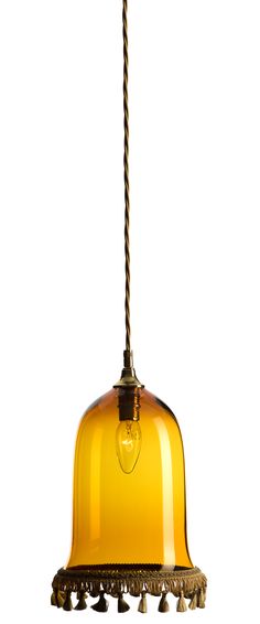 a yellow glass light hanging from a cord