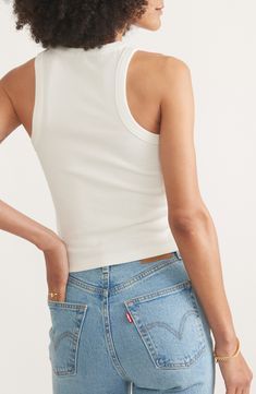 Sure to be a go-to for hot days, this fitted, cropped tank is made from stretchy ribbed fabric that's garment-dyed for a sun-faded look. Crewneck Sleeveless, with cutaway shoulders 49% cotton, 47% Tencel® lyocell, 4% spandex Tencel lyocell is a more-sustainably produced fiber made with closed-loop processing Machine wash, tumble dry Imported Seamless Cropped Tank Top, Sporty Crop Top For Everyday Summer Wear, Seamless Cotton Cropped Top, Seamless Cotton Crop Top For Everyday, Everyday Seamless Cotton Crop Top, Cotton Ribbed Racerback Crop Top, Ribbed Cotton Racerback Crop Top, Everyday Fitted Tank Crop Top, Fitted Tank Crop Top For Everyday