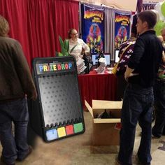 a group of people standing in front of a table with a sign that says pre - shop