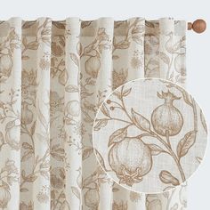 a curtain with a flower design on it and a round window valil in the background