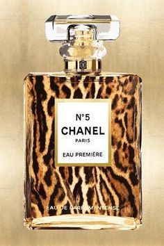 a bottle of chanel no 5 parfum on a gold background with an animal print pattern