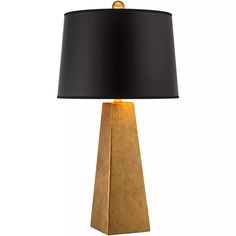 a table lamp with a black shade on the base and a gold colored metal base