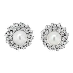 Behold the epitome of elegance and luxury with the Van Cleef & Arpels Estate Diamond and Pearl Bombe Earrings, a breathtaking testament to the artistry of fine jewelry. Crafted in exquisite 18k white gold, these earrings exude an aura of timeless sophistication that is synonymous with the Van Cleef & Arpels legacy. At the heart of these masterpieces lies a luminous white pearl, commanding attention with its impressive 16mm diameter. The pearl's pristine radiance is further enhanced by the opulence of its surroundings – a halo of meticulously arranged marquise-cut diamonds. With a total carat weight of approximately 20.00cttw, these diamonds glisten like celestial stars, adding an awe-inspiring brilliance to the earrings. The unique bombe design of the earrings accentuates their regal prese Earring Video, Gold Vans, Celestial Stars, Van Cleef & Arpels, Diamond Cluster Earrings, Pearl And Diamond Necklace, Van Cleef And Arpels, Earring Stand, White Gold Set