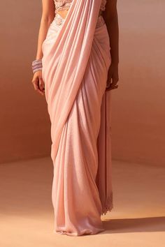 Blush pink sleeveless halter neck blouse with 3D flora, resham and stone embellishments. Paired with an embroidered waistband pre-draped shimmer satin saree. - Aza Fashions Draped Blouse Piece With Resham Embroidery, Elegant Draped Saree With Resham Embroidery, Elegant Embellished Pink Blouse Piece, Elegant Pink Saree Blouse Piece, Elegant Pink Blouse Piece With Traditional Drape, Elegant Festive Pink Pre-draped Saree, Pink Embellished Blouse Piece For Evening, Elegant Pink Blouse Piece For Evening, Pink Embellished Silk Pre-draped Saree