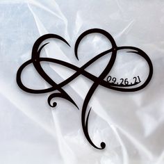 a heart shaped tattoo with the word love written in black ink on a white background