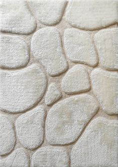 a white rug with rocks on it