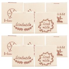 six handmade labels with the words made in brown ink on white linen, set of 6