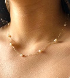 Classic and dainty freshwater and gold necklace. - 5x4mm Rice freshwater Pearl beads. - 14k Gold filled chain - 14k Gold filled closure. Adjustable 2 inches extender chain. * Custom orders welcome. Freshwater pearls are cultured pearls, grown in lakes, rivers, as well as ponds. Most Freshwater pearls are white and resemble Akoya pearls, but they also produce a variety of pastel shades, including pink, lilac and peach. Every once in awhile, you see things that bring you pure joy. Admire this neck Dainty Single Strand Pearl Necklace In 14k Gold, Dainty 14k Gold-filled Single Strand Pearl Necklace, Dainty Pearl Necklace With Round Beads, Dainty Pearl Necklace With Pearl Chain, Dainty Pearl White Pearl Necklace, Delicate Pearl Necklace With Tiny Beads, Dainty Yellow Gold Pearl Necklace, Pearl Necklace Bridal, Dainty Pearl Necklace