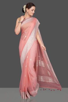 This is a traditional pure banarasi woven georgette saree in beautiful peach colour with an amazing zari weave. Saree features elegantly floriated zari border and pallu. The floral bootis is run throughout the body of the saree. The pallu has paisley bootis in zari weave, the pallu is finished with skill full tassels, which makes it more beautiful. Georgette gives a very beautiful drape owing to its flowy nature. Color: Peach Length: 5.5 Meters Width: 1.2 Meters Blouse: Running/attached blouse i Traditional Pre-draped Saree With Self Design, Traditional Ceremonies Pre-draped Saree With Self Design, Handloom Georgette Saree, Pre-draped Georgette Saree For Traditional Ceremonies, Semi-stitched Handloom Georgette Traditional Wear, Bollywood Style Handloom Traditional Wear In Georgette, Fitted Cotton Silk Traditional Wear With Zari Weaving, Georgette Dupatta With Zari Weaving, Fitted Traditional Wear With Zari Weaving In Cotton Silk