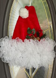 a red santa hat sitting on top of a door