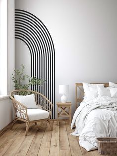 a white bed sitting next to a window in a room with wooden floors and walls