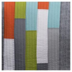 an orange, grey and green striped quilt