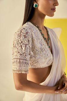 Editor's Note Embrace elegance and grace in this ivory net pearl embroidered elbow sleeves blouse and chiffon organza draped ruffled sari. The intricate pearl embroidery adds a touch of sophistication, while the cascading ruffles of the sari create a captivating look. Fabric: Blouse: net, sari: chiffon/organza Color: Ivory Components: Sari and blouse Occasion: Festive and Wedding Guest Note: Product colour may slightly vary due to photographic lighting sources Care: Dry clean only About the Desi Ivory Saree, Saree Chiffon, Pearl Blouse, Ridhi Mehra, Cultural Fashion, Saree Blouse Styles, Net Blouse, Blouse Ideas, Fashionable Saree Blouse Designs