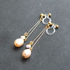 Light orange freshwater pearl clip on earrings dangle. bridal clip on earrings crystal. wedding clip earrings, non pierced earrings 💕💕 Why do you need invisible clip on earrings for your events? 💕💕 1)Comfortable to wear ➡ You will forget that you wear clip on earrings during your events. So you can smile and enjoy the events. 2)Pierced look: You can have a perfect look. ➡ Since invisible clip on earring findings are clear, so they seem pierced earrings. So if you have photo shooting, the cli Pearl Drop Dangle Clip-on Earrings For Wedding, Clip-on Dangle Pearl Earrings, Non Pierced Earrings, Fake Earrings, Bridal Clip, Wedding Clip, Pearl Earrings Wedding, Earrings Crystal, Hanging Earrings