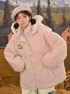 a girl in a pink coat and hat posing for the camera with her hands on her hips