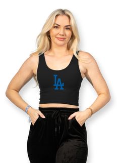 A much needed staple to rep your favorite team! Versatile enough to dress up or down, the logo crop tank is the everyday wardrobe staple for baseball fans! ✦ Black cropped tank✦ Royal blue MLB Dodgers logo ✦ Seamless, Ribbed, Cropped Tank Top ✦ 92% Nylon, 8% Spandex Collegiate Black Sleeveless Top, Sporty Logo Print Crop Top For Streetwear, Collegiate Sleeveless Top With Team Logo, Black Cropped Sports Bra, Sporty Streetwear Tank Top With Letter Print, Casual Black Cropped Sports Bra, Sleeveless Cotton Top With Team Logo, Sporty Sleeveless Top With Team Logo, Fitted Tops With Team Logo For Sports Events