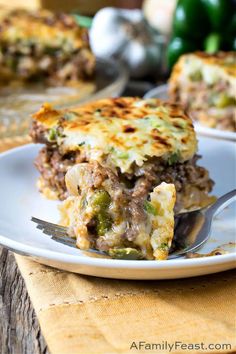 a slice of lasagna on a plate with a fork