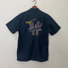 [DESCRIPTION] Please read the description first before buy my items‼️‼️ Vintage Dickies Embroidered Big Logo Tee Size on tag : M Tag says M,fits like M (please refer the actual measurements given and compare it with best fitting clothes,by using the size on tag is not always accurate) All in good condition [MATERIAL] Cotton [MEASUREMENT] Measurement:  armpit to armpit : 20 inches  Back collar to bottom : 28 inches [CONDITION] - All in good condition  - Kindly please refer photo [PAYMENT & NOTICE] - No return/refund - All items will be post over shipping company counter within 1-3 working days after payment completed and please allow 1-4 weeks for shipping delivery to your destination. -We are trusted seller. Do message me if you have any questions to ask about this item. -Dont Worry About Casual Embroidered Button-up Camp Shirt, Casual Embroidered Cotton Camp Shirt, Vintage Dickies, Button Ups, Fitting Clothes, Logo Tee, Mens Graphic Tee, Logo Tees, Logo T Shirt