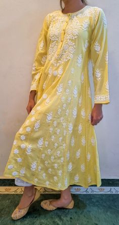 Made from Soft Pure Cotton , the Maharani Dress is Highlighted by Fish Kali panels to give it the voluminous flair The panels are distinguished from each other by different sets of motifs and embroidered intricately in Chikankari throughout the length of the piece. Prewashed. Preshrunk. Bucket wash and line dry and light iron for best results. Length - 48 inches sizes - S - fits bust 34 M - fits bust 36 L - fits bust 38 XL - fits bust 40 0X - fits bust 42 1X - fits bust 44 Anaar Kali Dress, Festival Tunic Dresses With Resham Embroidery, White Bohemian Dress With Cutdana, Maxi Length Dress With Chikankari Embroidery For Navratri, Navratri Maxi Dress With Chikankari Embroidery, Navratri Chikankari Embroidery Maxi Dress, Traditional Floor-length Dress With Chikankari Embroidery, Bohemian Cotton Designer Dress, Floor-length Anarkali Dress With Chikankari Embroidery