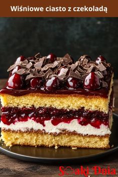 a piece of cake with cherries and chocolate on top is sitting on a plate