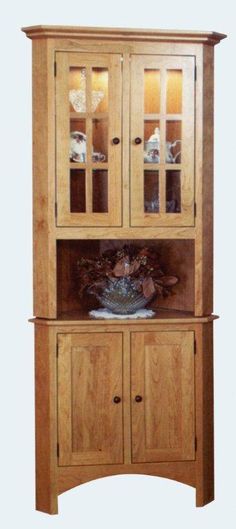 a wooden china cabinet with glass doors and drawers