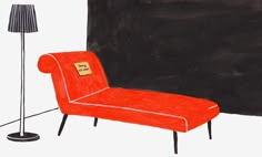 an orange chair sitting next to a black wall with a lamp on top of it