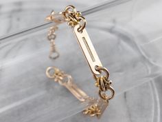 This Retro era chain was possibly part of a pocket watch chain at some stage, but now it makes a gorgeous bracelet! The fancy style of the links and two tones of 14k gold make for a stylish look with a bright polish. Beautiful on its own, this piece is also great for layering. Metal: 14K Rose and Yellow Gold Width: 6 mm Length: 7 Inches Marks: "14K" Stamped on the clasp Bracelet Fancy, Bracelet Layering, Retro Bracelet, Retro Era, Victorian Revival, Gold Link Bracelet, Pocket Watch Chain, Gold Link, Watch Chain