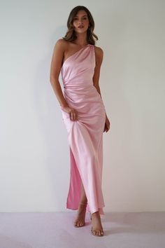 a woman in a pink dress posing for the camera