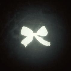 the silhouette of a bow on a black background is shown in white light, and it appears to be dark